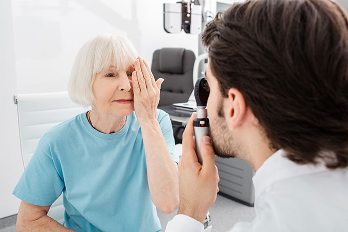 Old woman taking eye exam