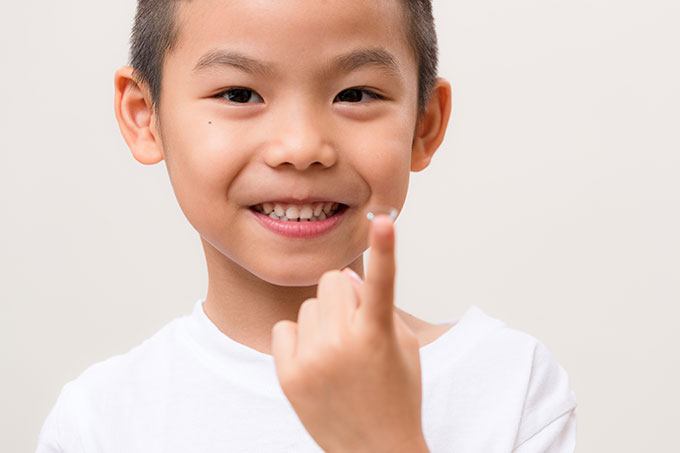 Young boy showing his contact lens